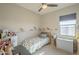 Cozy bedroom with a ceiling fan, window, dinosaur wall decals, and playful decor at 20142 W Sherman St, Buckeye, AZ 85326