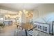 Open dining area with a modern chandelier and view of a large kitchen island at 20142 W Sherman St, Buckeye, AZ 85326