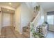 Bright entryway featuring tile flooring, a staircase with white railings, and a stylish wine rack at 20142 W Sherman St, Buckeye, AZ 85326