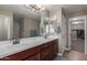 A bathroom with a double sink, a large mirror, walk in shower and a separate walk in closet at 20539 W Terrace Ln, Buckeye, AZ 85396