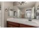 Neutral toned bathroom with white sink, dark wood cabinetry and hardware at 20539 W Terrace Ln, Buckeye, AZ 85396