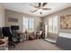 Cozy home office featuring a ceiling fan and bright windows with shutters at 20539 W Terrace Ln, Buckeye, AZ 85396