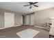Neutral bedroom with ceiling fan, carpet, and white trim and doors at 20539 W Terrace Ln, Buckeye, AZ 85396