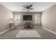 Bonus room featuring a large screen television, neutral colored walls, carpet and a ceiling fan at 20539 W Terrace Ln, Buckeye, AZ 85396