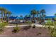 Community pool area with lush landscaping, palm trees, and ample space for lounging and relaxation at 20539 W Terrace Ln, Buckeye, AZ 85396