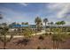 Community pool oasis with palm trees, shade structures, and well-maintained landscaping at 20539 W Terrace Ln, Buckeye, AZ 85396