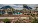 Relaxing community pool with blue umbrellas, seating, and beautiful landscaping features at 20539 W Terrace Ln, Buckeye, AZ 85396
