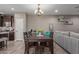 Well-lit dining area with a table and view into the kitchen and living spaces at 20539 W Terrace Ln, Buckeye, AZ 85396