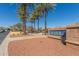 Inviting community entrance with lush palm trees and manicured landscaping by a decorative sign at 20539 W Terrace Ln, Buckeye, AZ 85396