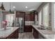 A kitchen with granite countertops, stainless steel appliances, a large sink and beautiful wood floors at 20539 W Terrace Ln, Buckeye, AZ 85396