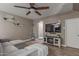 Inviting living room featuring a cozy fireplace, ceiling fan, and stylish decor at 20539 W Terrace Ln, Buckeye, AZ 85396