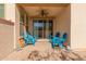 Relaxing covered patio with four chairs and brick flooring at 20539 W Terrace Ln, Buckeye, AZ 85396
