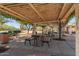 Charming pergola with picnic tables, benches, and a BBQ grill offers a relaxing outdoor space at 20539 W Terrace Ln, Buckeye, AZ 85396