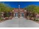 Stunning Heritage Swim Park entrance featuring an all-brick exterior with symmetrical landscaping at 20539 W Terrace Ln, Buckeye, AZ 85396