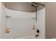 Bright white tiled shower with dark colored hardware and shelving at 20539 W Terrace Ln, Buckeye, AZ 85396