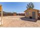 Large, private backyard featuring sand and a wooden fence at 207 E Cedar Ave, Casa Grande, AZ 85122