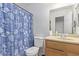Bathroom with seashell shower curtain, toilet, sink, and vanity at 207 E Cedar Ave, Casa Grande, AZ 85122