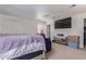 Bedroom features a large screen TV, a ceiling fan, and a comfortable bed and seating area at 207 E Cedar Ave, Casa Grande, AZ 85122