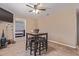 Dining room featuring a wooden table with leather stools and a ceiling fan at 207 E Cedar Ave, Casa Grande, AZ 85122