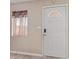 Entryway with a white front door with glass insert and security features at 207 E Cedar Ave, Casa Grande, AZ 85122