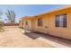 Tan single-story home with minimal front landscaping and covered walkway to front door at 207 E Cedar Ave, Casa Grande, AZ 85122