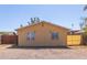 Small single-story house with a tan exterior, minimal landscaping, and marked with the number 207 at 207 E Cedar Ave, Casa Grande, AZ 85122