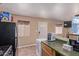 Functional kitchen space with essential appliances and a connection to the dining area at 207 E Cedar Ave, Casa Grande, AZ 85122