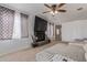 Living room with large TV, fireplace, and ceiling fan at 207 E Cedar Ave, Casa Grande, AZ 85122