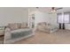 Living room with carpet, comfortable sofas, and a view into another room at 207 E Cedar Ave, Casa Grande, AZ 85122
