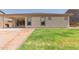 Home backyard with patio, desert landscaping, and well-maintained lawn area at 21165 E Thornton Rd, Queen Creek, AZ 85142