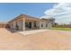 Wide backyard with a covered patio, seating, and desert-style landscaping at 21165 E Thornton Rd, Queen Creek, AZ 85142