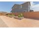 Backyard showcasing garden beds, desert landscaping, and a block wall fence at 21165 E Thornton Rd, Queen Creek, AZ 85142