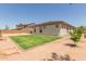 Home backyard with patio, desert landscaping, and well-maintained lawn area at 21165 E Thornton Rd, Queen Creek, AZ 85142