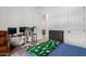 Well-lit bedroom boasts a workspace with dual monitors, a comfortable chair, and ample storage at 21165 E Thornton Rd, Queen Creek, AZ 85142
