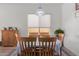 Dining area with a wooden table and chairs set beneath a decorative light fixture at 21165 E Thornton Rd, Queen Creek, AZ 85142