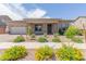 Charming single-story home with stone accents, landscaped front yard, and a two-car garage at 21165 E Thornton Rd, Queen Creek, AZ 85142