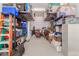 Well-organized garage featuring storage racks, shelves, and various household items at 21165 E Thornton Rd, Queen Creek, AZ 85142