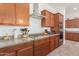 Kitchen with granite countertops, stainless steel appliances, and wooden cabinets at 21165 E Thornton Rd, Queen Creek, AZ 85142