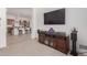 This living room offers an open floor plan with a modern entertainment center and access to the kitchen at 21165 E Thornton Rd, Queen Creek, AZ 85142