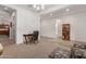 Bright living room has an open floor plan with a desk setup, bookcase, and comfortable seating at 21165 E Thornton Rd, Queen Creek, AZ 85142