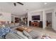 Open living space featuring a large sectional sofa, ceiling fan, and views of the adjacent kitchen at 21165 E Thornton Rd, Queen Creek, AZ 85142