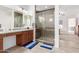 Bathroom featuring double vanity, glass shower and view of the bedroom at 21165 E Thornton Rd, Queen Creek, AZ 85142
