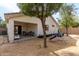 Backyard featuring a covered patio, well-maintained trees, and a playground for outdoor enjoyment at 23830 W Chambers St, Buckeye, AZ 85326