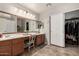 Bathroom with a large vanity, double sinks, and a walk-in closet at 23830 W Chambers St, Buckeye, AZ 85326