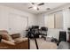 Bedroom with neutral walls, carpet, a ceiling fan, closet, workstation and a comfortable sofa for relaxing at 23830 W Chambers St, Buckeye, AZ 85326