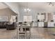 Open-concept living and dining area featuring wood floors and bright, natural light at 23830 W Chambers St, Buckeye, AZ 85326