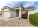 Inviting home exterior featuring manicured landscaping and a covered front entrance at 23830 W Chambers St, Buckeye, AZ 85326
