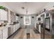 Well-lit kitchen featuring stainless steel appliances, white cabinets, and a movable island at 23830 W Chambers St, Buckeye, AZ 85326