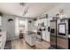Modern kitchen with stainless steel appliances, white cabinets, and a cozy center island at 23830 W Chambers St, Buckeye, AZ 85326