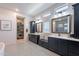 Elegant bathroom with dual vanities, geometric tile flooring, and a walk-in closet at 25751 S 227Th Way, Queen Creek, AZ 85142
